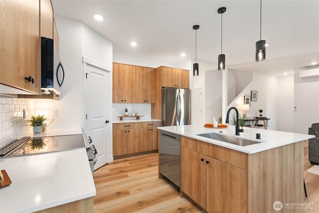 251 Sweet Gum Dr, Blaine, WA 98230 - kitchen featuring appliances with stainless steel finishes, a wall mounted air conditioner, backsplash, light wood-type flooring, and light countertops