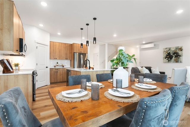 251 Sweet Gum Dr, Blaine, WA 98230 - dining area featuring light wood-style floors, a wall mounted AC, stairs, and recessed lighting