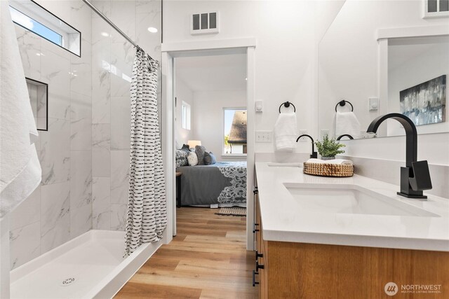 251 Sweet Gum Dr, Blaine, WA 98230 - ensuite bathroom featuring double vanity, a marble finish shower, and wood finished floors