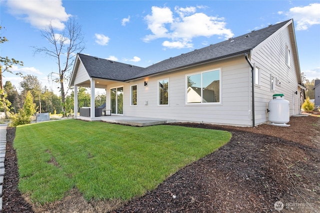 251 Sweet Gum Dr, Blaine, WA 98230 - rear view of house with a patio, a yard, and roof with shingles