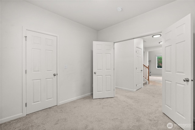 7701 Rushmore Ave NE, Lacey, WA 98516 - unfurnished bedroom featuring light carpet and baseboards