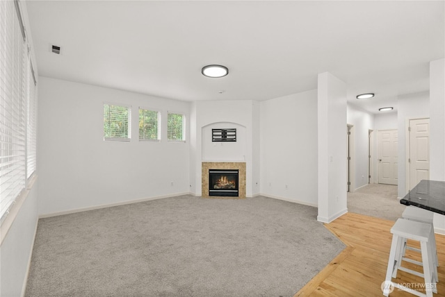 7701 Rushmore Ave NE, Lacey, WA 98516 - unfurnished living room with a fireplace with flush hearth, wood finished floors, and carpet
