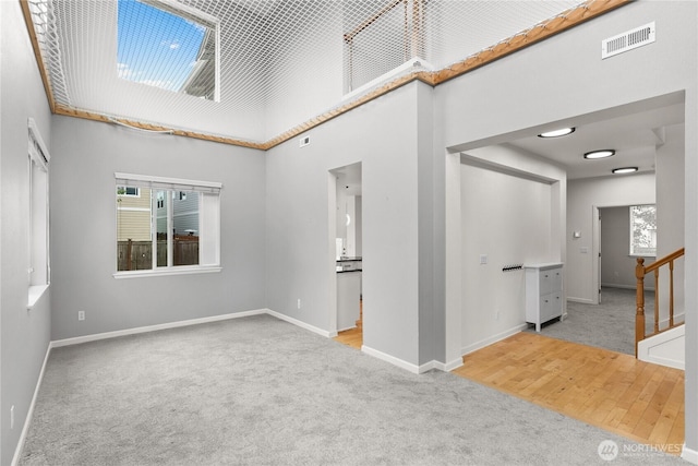 7701 Rushmore Ave NE, Lacey, WA 98516 - carpeted spare room featuring a towering ceiling and stairs