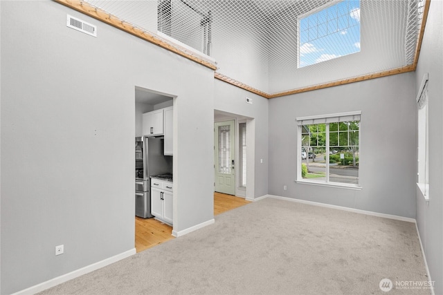 7701 Rushmore Ave NE, Lacey, WA 98516 - spare room featuring light colored carpet and a high ceiling