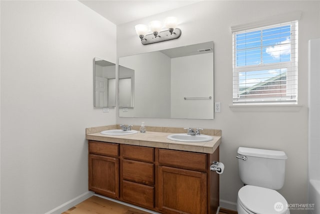 7701 Rushmore Ave NE, Lacey, WA 98516 - full bath featuring double vanity, healthy amount of natural light, and wood finished floors