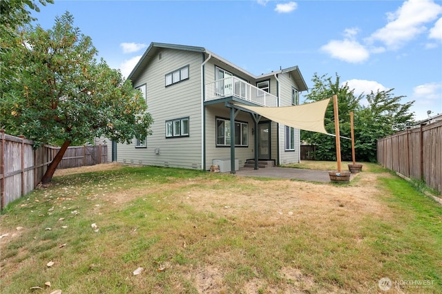 7701 Rushmore Ave NE, Lacey, WA 98516 - back of property featuring a balcony, a fenced backyard, a patio, and entry steps