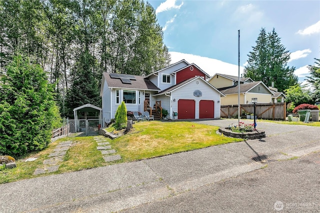 25128 168th Pl SE, Covington, WA 98042 - view of front facade featuring driveway, roof mounted solar panels, and a garage