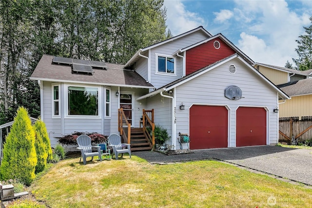 25128 168th Pl SE, Covington, WA 98042 - view of front facade with an attached garage, roof mounted solar panels, and asphalt driveway