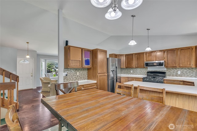 25128 168th Pl SE, Covington, WA 98042 - kitchen with stainless steel appliances, light countertops, decorative backsplash, and vaulted ceiling
