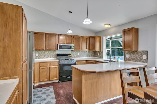 25128 168th Pl SE, Covington, WA 98042 - kitchen featuring appliances with stainless steel finishes, a peninsula, lofted ceiling, a breakfast bar area, and hanging light fixtures