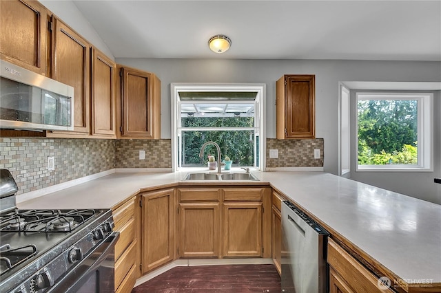 25128 168th Pl SE, Covington, WA 98042 - kitchen with stainless steel appliances, light countertops, a peninsula, backsplash, and lofted ceiling