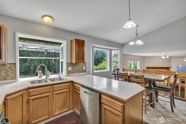 25128 168th Pl SE, Covington, WA 98042 - kitchen with stainless steel dishwasher, a peninsula, vaulted ceiling, decorative backsplash, and light countertops