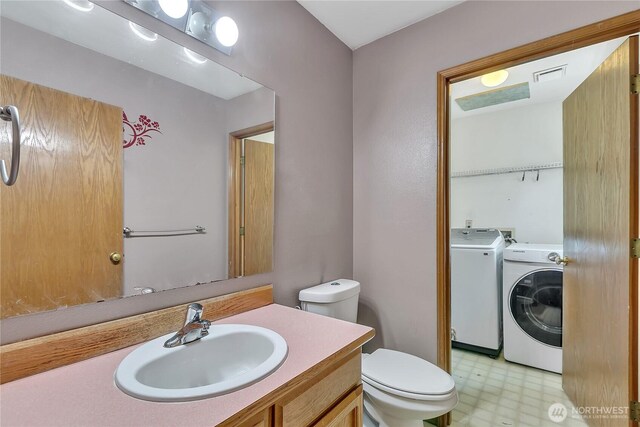 25128 168th Pl SE, Covington, WA 98042 - bathroom with washing machine and dryer, tile patterned floors, and vanity