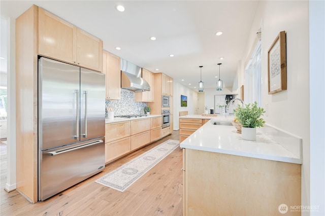 804 109th Ave SE, Bellevue, WA 98004 - kitchen featuring built in appliances, light brown cabinetry, wall chimney range hood, light wood finished floors, and recessed lighting