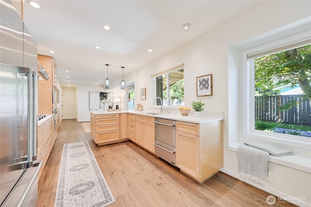 804 109th Ave SE, Bellevue, WA 98004 - kitchen featuring light brown cabinetry, stainless steel appliances, healthy amount of natural light, light wood-type flooring, and recessed lighting