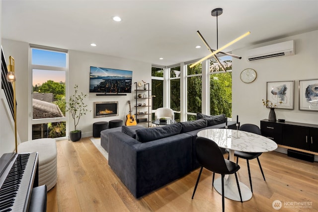 5404 26th Ave SW, Seattle, WA 98106 - living area featuring a wall mounted air conditioner, light wood-style floors, plenty of natural light, a warm lit fireplace, and recessed lighting