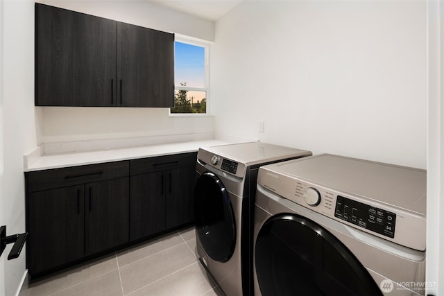5404 26th Ave SW, Seattle, WA 98106 - laundry area featuring cabinet space, independent washer and dryer, and light tile patterned floors