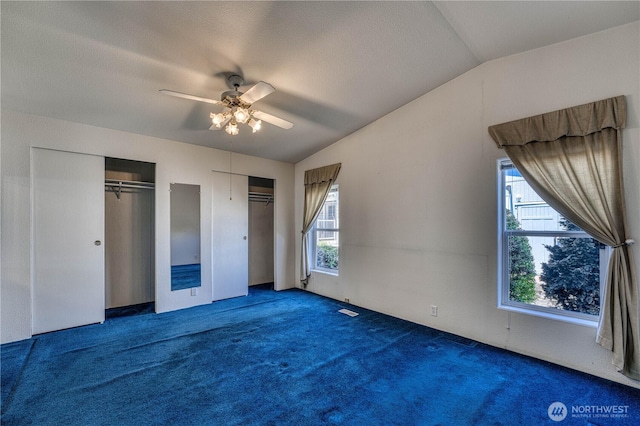 1915 140th St E Unit 193, Tacoma, WA 98445 - unfurnished bedroom with multiple closets, lofted ceiling, carpet flooring, and ceiling fan