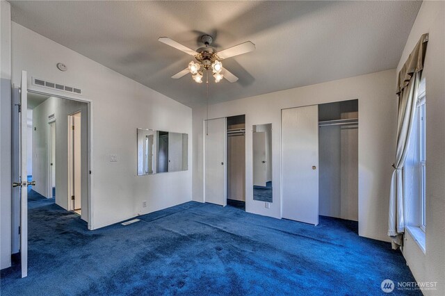 1915 140th St E Unit 193, Tacoma, WA 98445 - unfurnished bedroom with two closets, carpet, and a ceiling fan