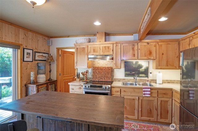 13285 Wye Lake Blvd SW, Port Orchard, WA 98367 - kitchen with under cabinet range hood, stainless steel appliances, decorative backsplash, a kitchen island, and wooden walls