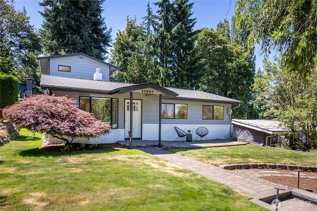 11627 NE 75th St, Kirkland, WA 98033 - view of front of property with a front yard, brick siding, and roof with shingles