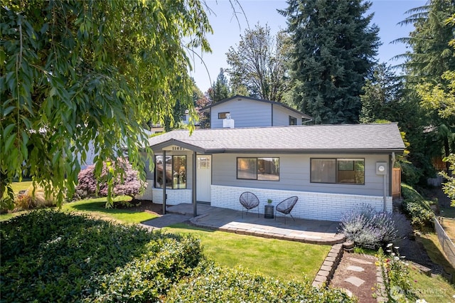 11627 NE 75th St, Kirkland, WA 98033 - view of front of house featuring brick siding, roof with shingles, a patio area, and a front lawn