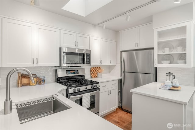 11627 NE 75th St, Kirkland, WA 98033 - kitchen with appliances with stainless steel finishes, light countertops, tasteful backsplash, and white cabinetry