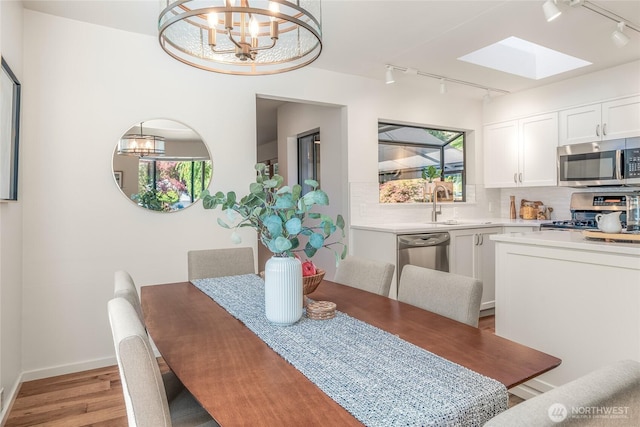 11627 NE 75th St, Kirkland, WA 98033 - dining area with track lighting, a chandelier, and a skylight