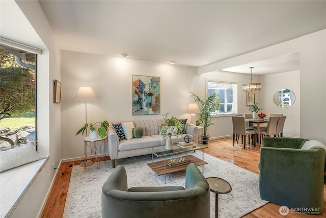11627 NE 75th St, Kirkland, WA 98033 - living room featuring wood finished floors, plenty of natural light, and a chandelier