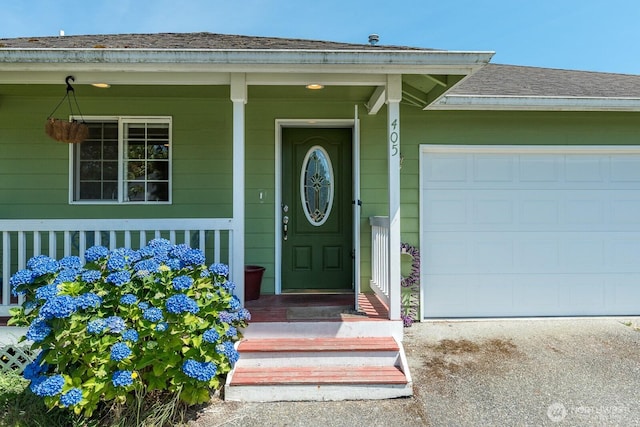 405 Spring Ln, Sedro Woolley, WA 98284 - entrance to property featuring an attached garage, concrete driveway, a shingled roof, and covered porch