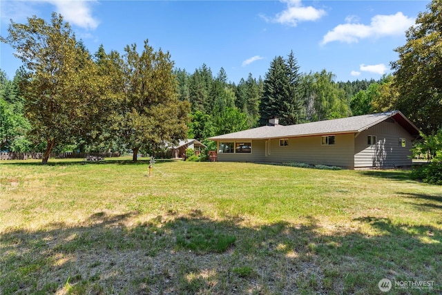 9327 E Leavenworth Rd, Leavenworth, WA 98826 - view of green lawn featuring a wooded view