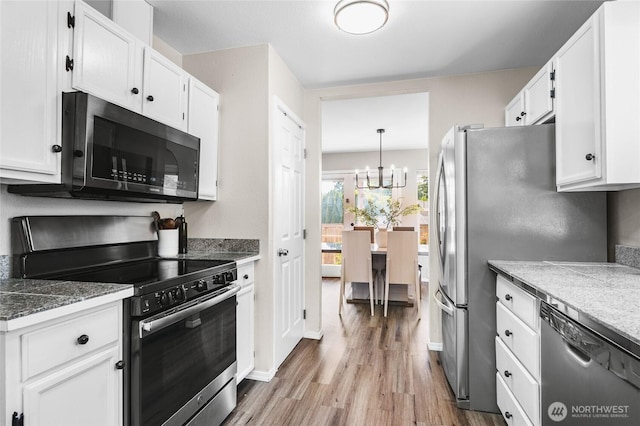 1617 SW 324th Pl, Federal Way, WA 98023 - kitchen with stainless steel appliances, light wood-style flooring, white cabinetry, and a chandelier