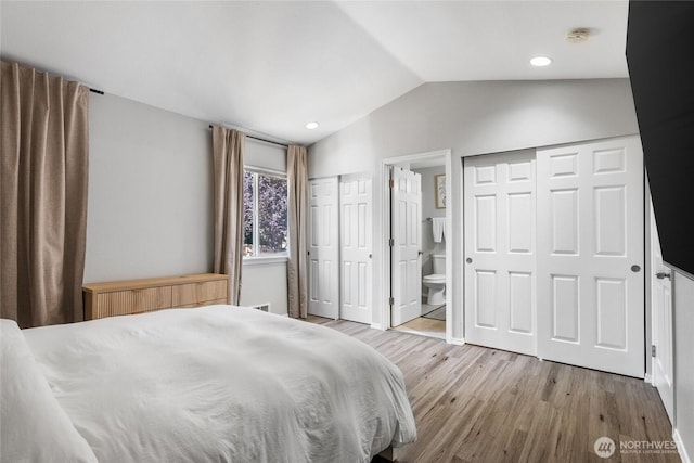 1617 SW 324th Pl, Federal Way, WA 98023 - bedroom with wood finished floors, vaulted ceiling, multiple closets, ensuite bathroom, and recessed lighting