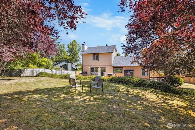 1617 SW 324th Pl, Federal Way, WA 98023 - back of house with a chimney, a fenced backyard, and roof with shingles