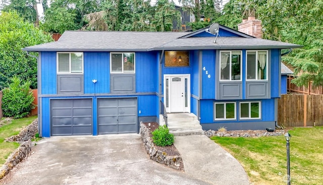 416 142nd Street Ct S, Tacoma, WA 98444 - split foyer home with an attached garage, driveway, a chimney, and a shingled roof