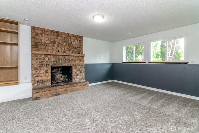 416 142nd Street Ct S, Tacoma, WA 98444 - unfurnished living room with a textured ceiling, carpet flooring, and a fireplace