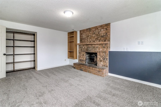 416 142nd Street Ct S, Tacoma, WA 98444 - unfurnished living room with carpet, a fireplace, and a textured ceiling
