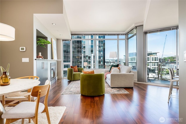 2121 Terry Ave Unit 1402, Seattle, WA 98121 - living area featuring dark wood-type flooring, floor to ceiling windows, and a fireplace