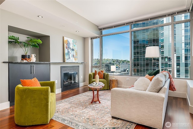 2121 Terry Ave Unit 1402, Seattle, WA 98121 - living area with a glass covered fireplace, wood finished floors, and recessed lighting