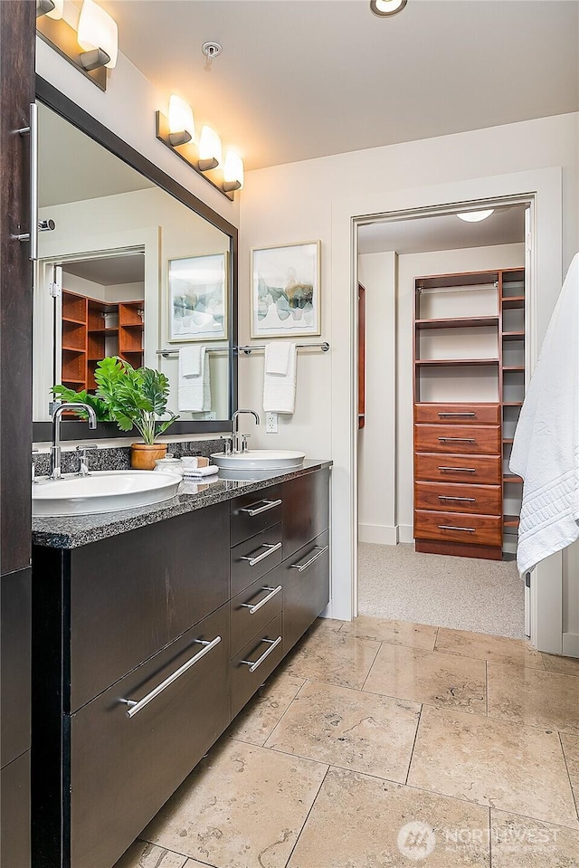 2121 Terry Ave Unit 1402, Seattle, WA 98121 - bathroom featuring double vanity and stone tile floors