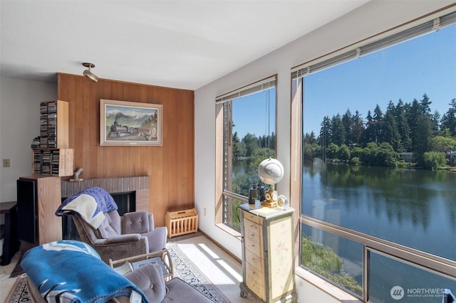 19524 Echo Lake Pl N Unit A-402, Shoreline, WA 98133 - sitting room with wooden walls, a water view, an accent wall, and a brick fireplace
