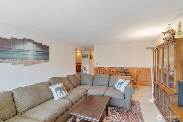 19524 Echo Lake Pl N Unit A-402, Shoreline, WA 98133 - living room featuring a wainscoted wall, light colored carpet, and wooden walls