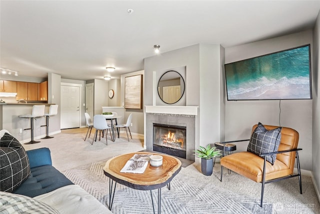 7711 NE 175th St Unit E110, Kenmore, WA 98028 - living room featuring light colored carpet and a glass covered fireplace