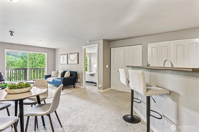 7711 NE 175th St Unit E110, Kenmore, WA 98028 - dining area with light carpet and baseboards