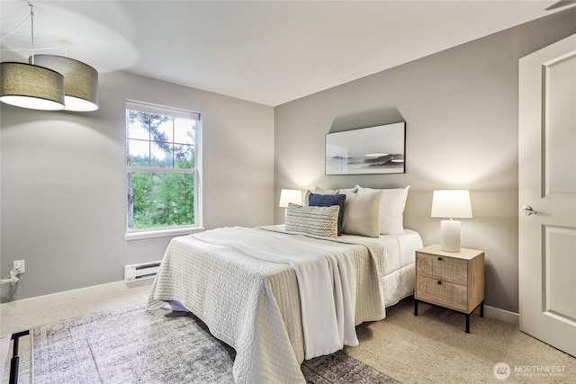 7711 NE 175th St Unit E110, Kenmore, WA 98028 - carpeted bedroom featuring a baseboard heating unit and baseboards