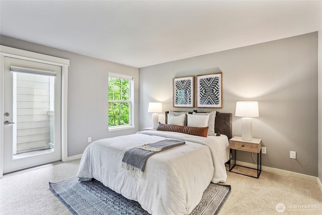 7711 NE 175th St Unit E110, Kenmore, WA 98028 - carpeted bedroom featuring baseboards and access to outside