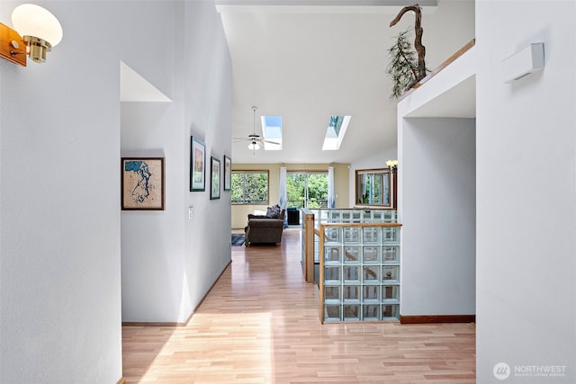 2815 60th Street Ct NW, Gig Harbor, WA 98335 - corridor with a skylight, wood finished floors, and high vaulted ceiling