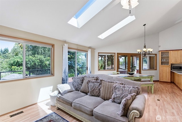 2815 60th Street Ct NW, Gig Harbor, WA 98335 - living area with a chandelier, lofted ceiling, a skylight, and light wood finished floors