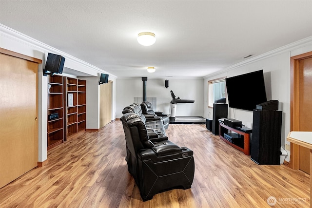 2815 60th Street Ct NW, Gig Harbor, WA 98335 - living room featuring a wood stove, ornamental molding, and light wood-type flooring