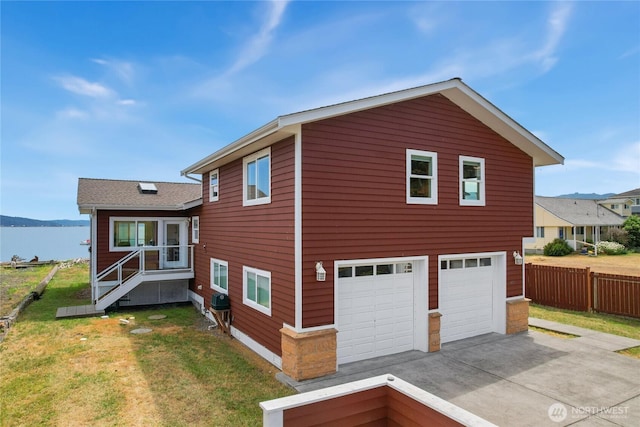 451 Beach Dr, Sequim, WA 98382 - view of home's exterior featuring a garage, a water view, and driveway